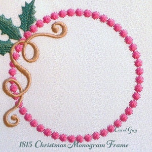 May include: A pink and green Christmas monogram frame with a holly leaf and berry design. The frame is made of embroidery and has a gold ribbon.
