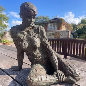 クリスティン・バクスター作「腕に寄りかかるブロンズ樹脂彫刻」