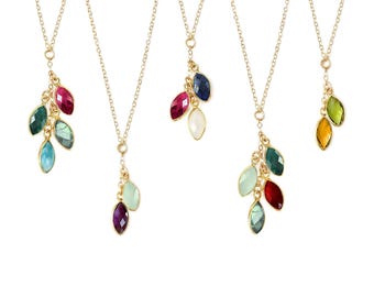 May include: Five gold-tone necklaces, each featuring a delicate chain and a cluster of marquise-cut faceted gemstones in various colors including red, blue, green, yellow, and clear, suspended as pendants from the bottom of each chain.