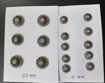 Silver set of 16 buttons.