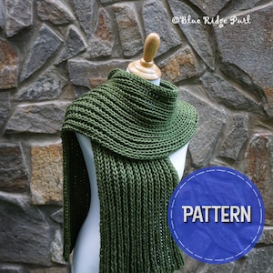 May include: A green knitted scarf with a ribbed texture, draped over a white mannequin. The scarf is folded in half and the ends are hanging down. The background is a stone wall. The text "PATTERN" is on a blue circle.