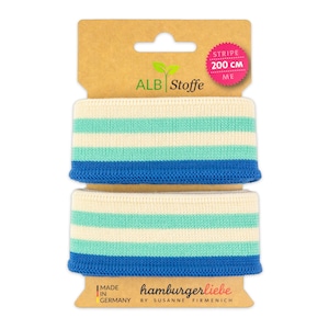Könnte beinhalten: Zwei Rollen weiß-blau-türkis gestreiftes Strick-Gummiband, jeweils 200 cm lang. Das Band ist auf einem Karton verpackt mit dem Markennamen "ALB Stoffe" und dem Text "Stripe 200 cm" in Pink. Die Verpackung enthält auch den Text "Made in Germany" und "hamburgerliebe by Susanne Firmenich".