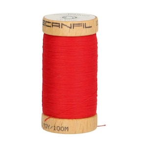 May include: A spool of red thread with a wooden bobbin. The bobbin is labeled "100Y/100M" and "Scanfil".