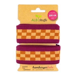 Könnte beinhalten: Eine Rolle pink-orange kariertes Band mit 200 cm Breite. Auf der Verpackung steht "ALBI Stoffe" und "hamburgerliebe by SUSANNE FIRMENICH".