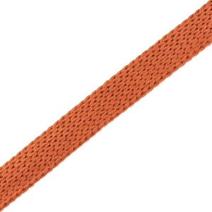 May include: A close-up of a brown woven fabric strap.