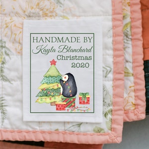 Christmas quilt label handmade by personalized name Christmas personalized date, christmas tree with penguin hanging up lights, cotton sew on or polyester sew on quilt label. by Jammin' Threads