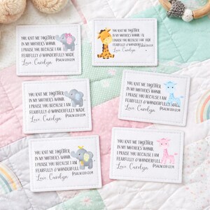 May include: White fabric patches with illustrations of an elephant, giraffe, and text. The patches have the text "You knit me together in my mother's womb..." and "Love Carolyn" with Psalm 139:13-14.