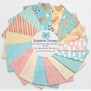 May include: A collection of sixteen fat quarter fabric pieces arranged in a circular pattern. The fabrics feature various pastel colors and patterns, including stripes, gingham, stars, rainbows, and animal prints. The center of the image displays the text "Rainbow Dreams" and "Fat Quarter Bundle".