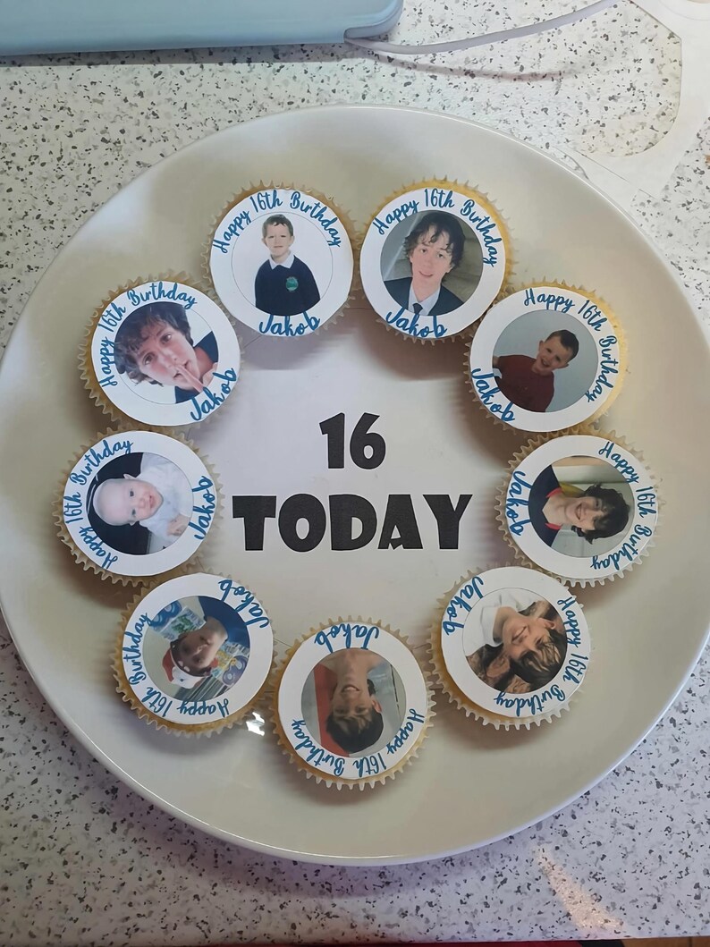 May include: A white plate with nine cupcakes decorated with photos of a young man at different ages. The cupcakes are arranged in a circle around the number "16" and the word "TODAY". Each cupcake has the text "Happy 16th Birthday" and "Jakob" written on it.