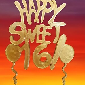 May include: Gold-colored Happy Sweet 16 cake topper with two balloons. The topper is against a gradient background of purple, red, orange, and yellow.