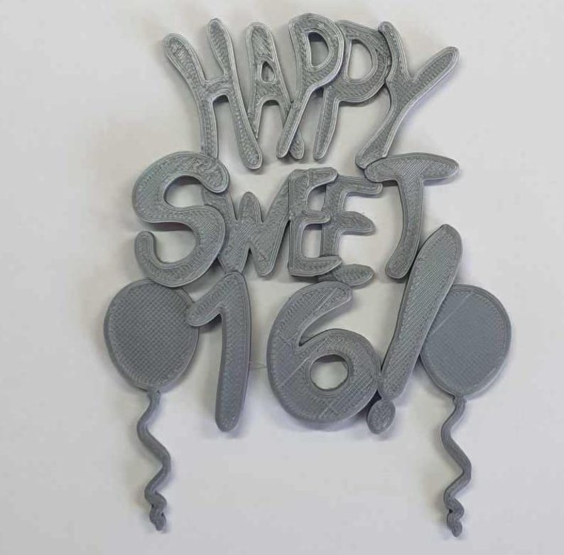 May include: Gray 3D printed cake topper with the words "Happy Sweet 16!" and two balloons.