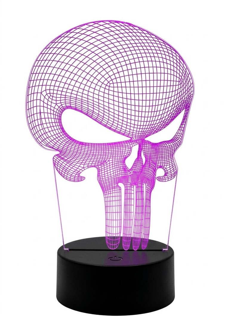 May include: A purple wireframe skull-shaped LED lamp. The skull design is illuminated with a bright purple light and sits on a black circular base. The lamp is a decorative item.