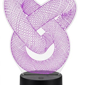 May include: A modern, geometric 3D illusion lamp. The design features a purple, intertwined shape with a grid pattern, mounted on a black base. The lamp is designed to create a visual effect when illuminated.