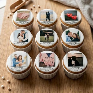 May include: Nine cupcakes with edible photo toppers arranged on a wooden board. Each cupcake has a different engagement photo and the text "We're Engaged" with a date and names. The cupcakes are in white paper liners.