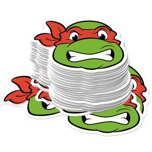May include: A stack of stickers featuring a green turtle head with a red mask, white teeth, and a determined expression. The stickers are white with a glossy finish. The text "© 2024 Viacom" is visible on the stickers.
