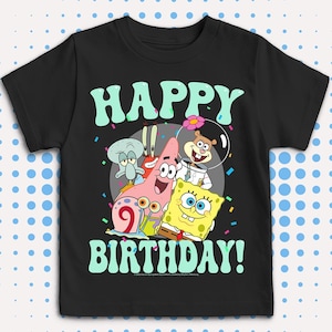 May include: Black t-shirt featuring the words "HAPPY BIRTHDAY!" in light green, with cartoon characters from SpongeBob SquarePants. The characters include SpongeBob, Patrick Star, Squidward, Mr. Krabs, and Sandy Cheeks.