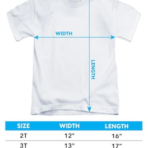 May include: White toddler short-sleeve t-shirt with sizing information. The image includes measurements for width and length. Sizes 2T, 3T, and 4T are listed with corresponding measurements in inches. The text "Allow +/- 1/2 inch tolerance on all measurements" is also included.