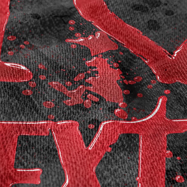 May include: Close-up of a black fabric with red text and splatters. The red text appears to be part of a larger word, with a glossy, dripping effect. The fabric has a textured appearance.