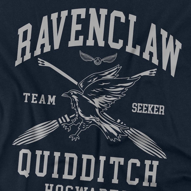 May include: Navy blue t-shirt featuring a Ravenclaw Quidditch design. The design includes the text "RAVENCLAW", "TEAM", "SEEKER", and "QUIDDITCH" in white, along with a raven, a snitch, and crossed brooms. The shirt is a fan item.