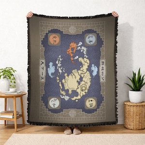 May include: A rectangular throw blanket featuring a map design with various symbols and text. The blanket has a dark blue background with a detailed map in shades of tan, orange, and white. The border is a darker brown with fringe.