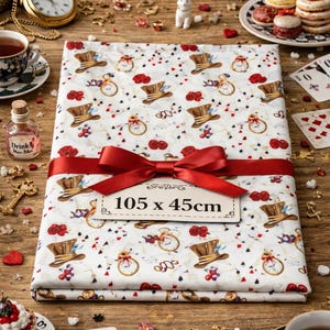 Op de afbeelding: Een gevouwen stof, 105 x 45cm, met een Alice in Wonderland-thema, met hoge hoeden, zakhorloges en rozen op een witte achtergrond. Een rood lint is om de stof gebonden. De scène omvat theekopjes, speelkaarten en decoratieve items.