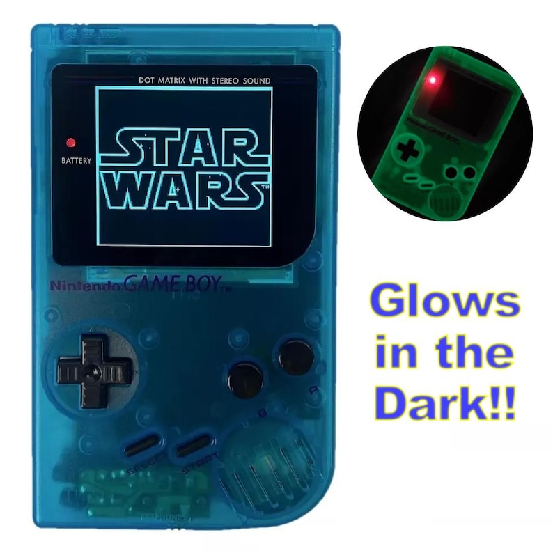 May include: A blue Game Boy handheld console with a black and white screen displaying the words "STAR WARS". The console has a black button pad and a red battery indicator. The console glows in the dark.