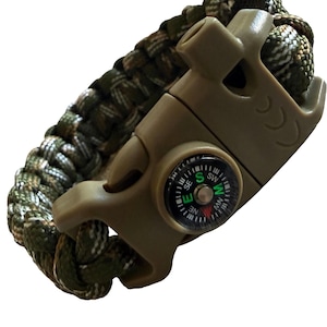 May include: A survival bracelet crafted from olive green and camouflage paracord, featuring a tan plastic side-release buckle. The buckle includes an integrated small circular compass with black, white, and green markings and a whistle.