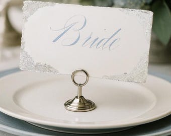 Dusty Blue Calligraphy Place Card with Silver Leaf Edges – Elegant Wedding Name Card