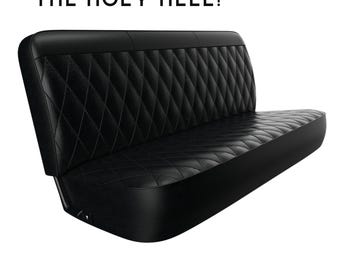 May include: Black leather car seat with diamond-stitched upholstery. The seat is folded down and has a black metal frame. The text "THE HOLY HELL!" is written above the seat.