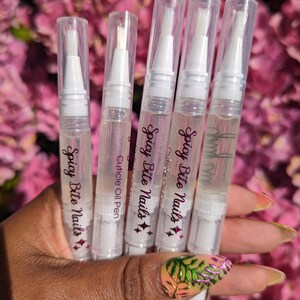 May include: Five clear plastic bottles with white caps and applicators. Each bottle contains a clear liquid and has the text "Spicy Bite Nails" and a diamond design printed on the label.
