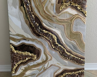 May include: Abstract painting on canvas with a white, brown, and gold colour scheme. The painting features a swirling, agate-like pattern with gold glitter accents.