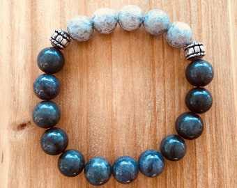 May include: A bracelet made of dark blue and light gray beads with silver accents.