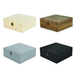 May include: Four wooden boxes in different colors: natural, brown, gray, and black. Each box is square with a hinged lid and a metal clasp. The boxes are made of wood and have a simple, classic design.