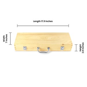 May include: A light-coloured wooden box with a silver handle and two silver latches. The box is 45.5 cm long, 17.8 cm wide, and 7.1 cm high. The box has a natural wood grain finish.