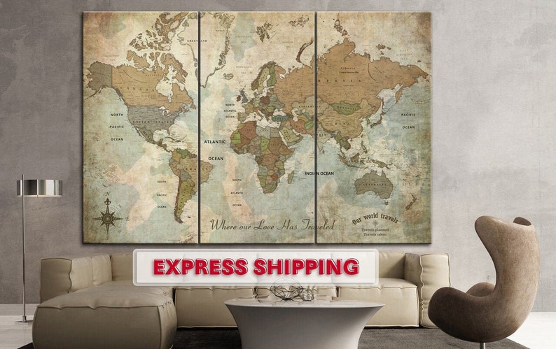May include: A vintage-style world map print on canvas, divided into three panels. The map is in shades of brown, green, and blue, with the text "Where our Love Has Traveled" and "Our world travels" printed on the bottom.