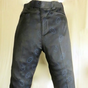 May include: Black pants with a blue circular pattern.