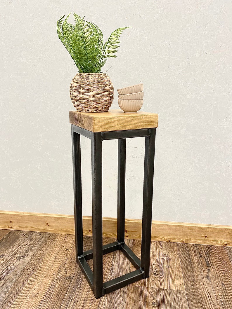 Industrial metal and wood narrow side table shown in modern decor