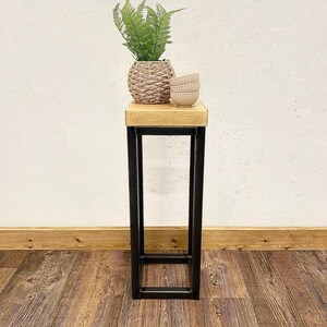 Rustic wooden plant stand displaying houseplant in living room