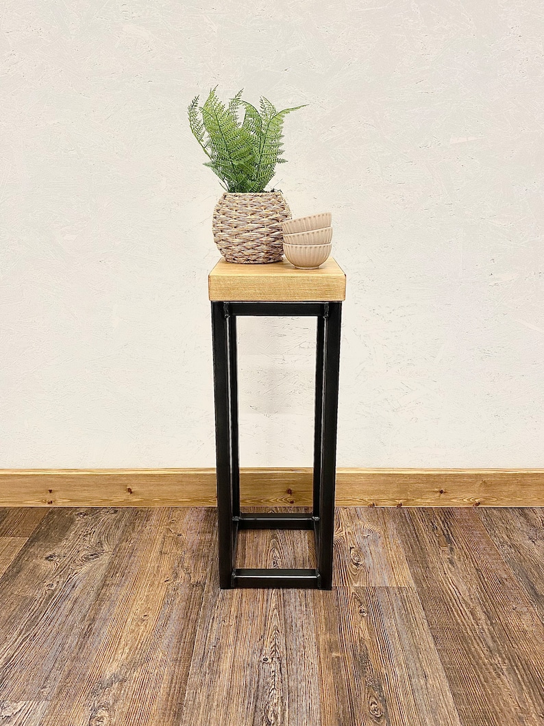 Rustic wooden plant stand displaying houseplant in living room