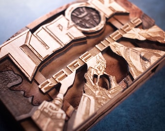 May include: A wooden box with a detailed laser-cut design featuring the word "TOROK" and intricate patterns. The box is made of light brown wood with a natural finish.