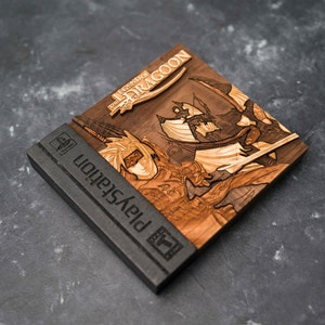 May include: A wooden PlayStation game case with a laser-engraved image of the game "The Legend of Dragoon". The case is black with the PlayStation logo and a "T" rating.