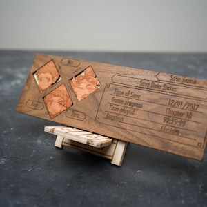 May include: A wooden save game status display with a carved design. The display shows the save date, game progress, time played, and location. The display also features three character portraits.