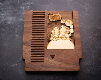 May include: A wooden NES game cartridge replica featuring the characters from the game "The Bubble Bobble". The cartridge is made of walnut wood and has a laser-engraved image of the game's characters.
