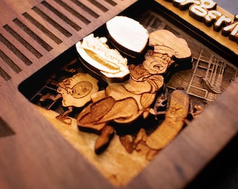 May include: A wooden cutout of a video game cartridge with the text "BurgerTime" on the label. The cutout is detailed with a chef character holding a burger and a background of a kitchen.