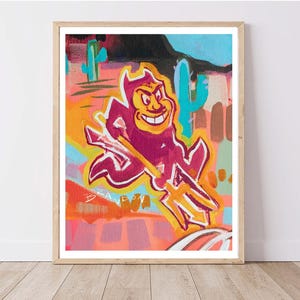 May include: A colorful painting of a cartoon devil holding a trident. The devil is red and purple with a yellow face and a black outline. The background is a mix of bright colors, including yellow, orange, pink, blue, and green. The painting is signed "BRANDON".