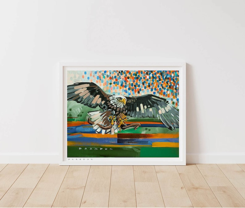 May include: A colorful abstract painting of a bald eagle with its wings spread wide. The eagle is flying over a field of green, blue, and orange. The background is a field of colorful dots. The painting is signed "BRANDON".