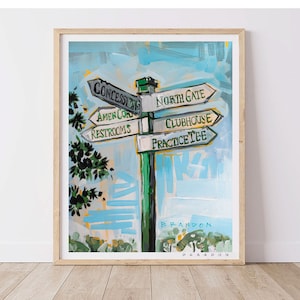May include: A colorful painting of a signpost with multiple directional arrows pointing to different locations on a golf course. The signpost is green and white with black lettering. The arrows point to "Concessions", "Amen Corner", "Restrooms", "North Gate", "Clubhouse", and "Practice Tee". The background is a blue sky with white clouds. The artist's signature, "Brandon", is visible at the bottom of the painting.
