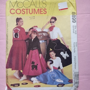May include: McCall's Costumes sewing pattern featuring a 1950s theme. The pattern cover shows four people wearing poodle skirts and other retro outfits. The text on the cover includes "COSTUMES" and "50%", with the pattern number 8899.