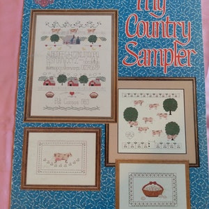 My Country Sampler Cross Stitch Pattern. Designs by Gloria and Pat. cows, Eggs, Trees. Personalize.