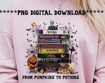 May include: Pink sweatshirt featuring a stack of Halloween-themed VHS tapes with titles like "Hocus Pocus" and "Goosebumps." The design includes bats, cobwebs, a pumpkin, and the text "FROM PUMPKINS TO POTIONS."